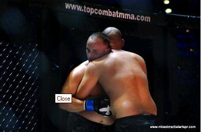 Carlos Colon works the clinch